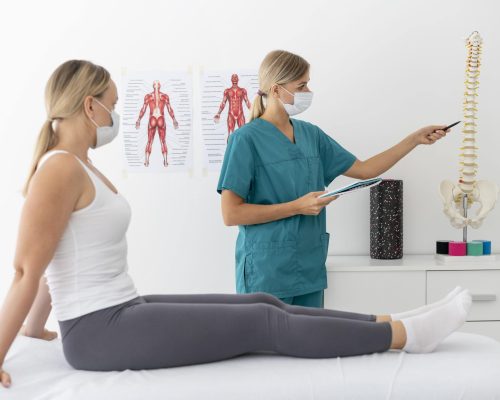 young-physiotherapist-helping-patient-with-back-problems-min